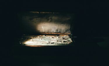 A vintage toolbox with various tools illuminated by sunlight. Captured indoors in Türkiye.