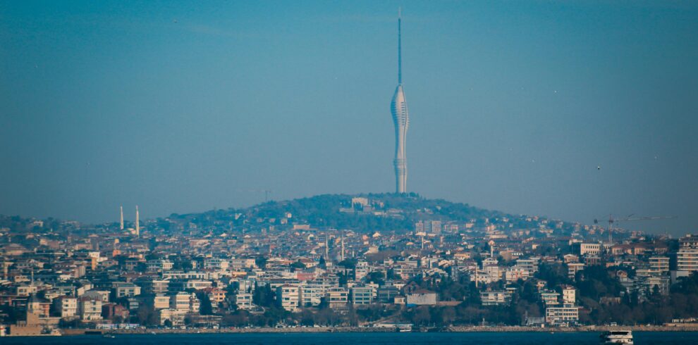 Expansive view of Istanbul cityscape with Camlica Tower rising prominently against the blue sky.