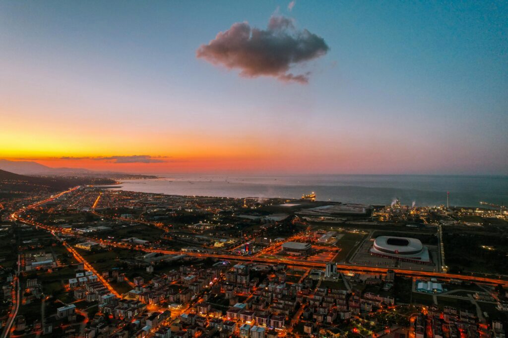 A breathtaking aerial view of Samsun at sunset, showcasing the cityscape and coastline in vivid colors.
